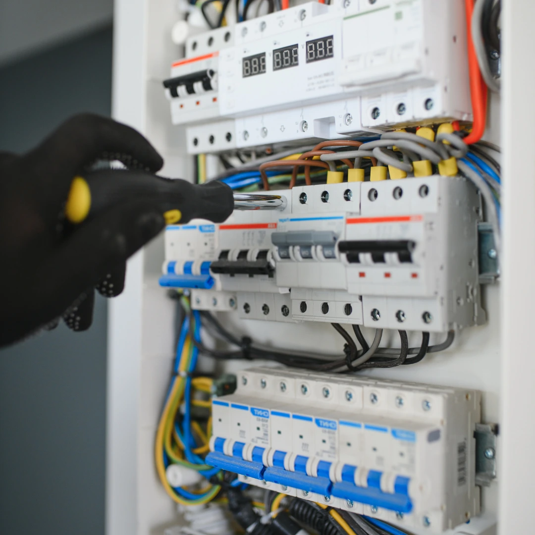 Emergency Electrical Services technician repairing panel