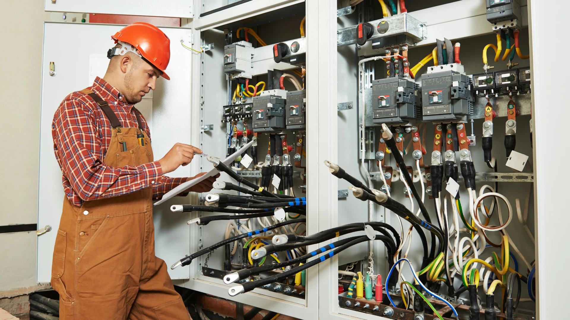 Practices for Home Electrical Maintenance — licensed electrician inspecting a residential service panel