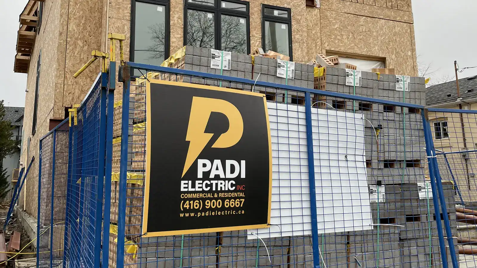 Padi Electric sign on the fence of a new construction site in the GTA