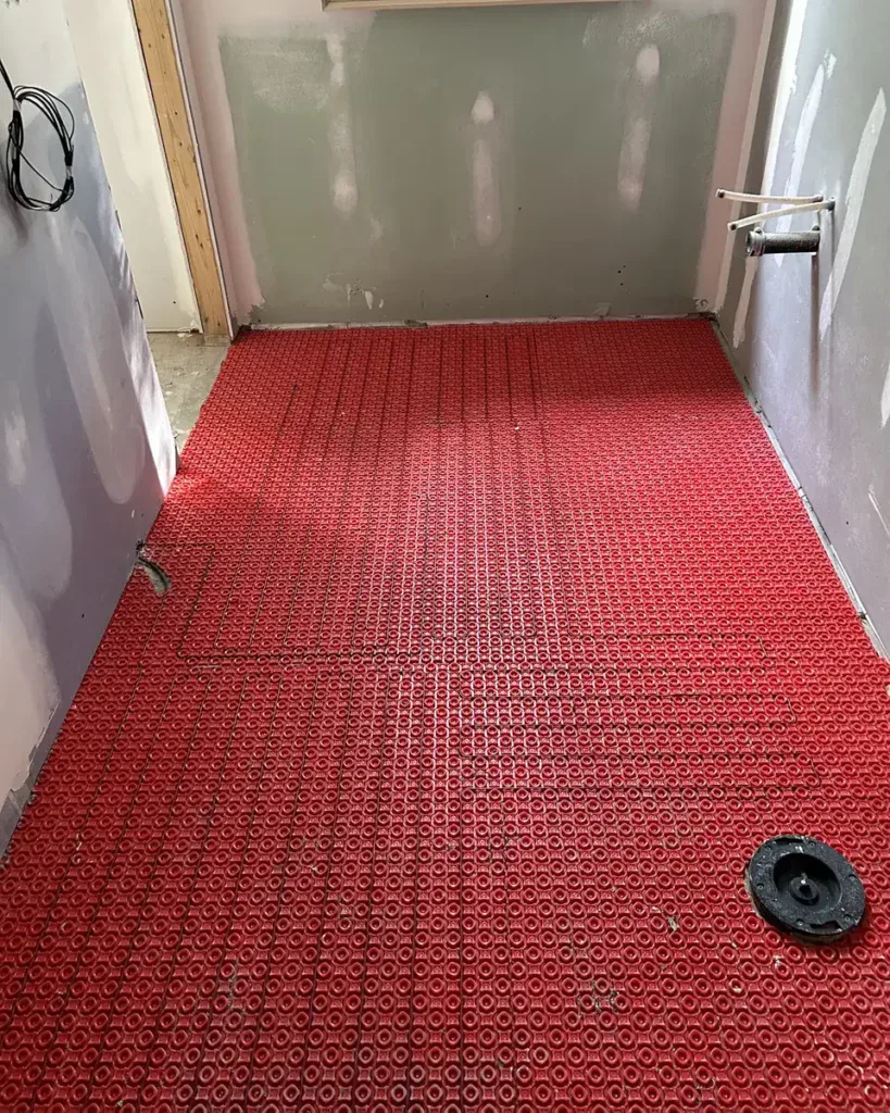 Electric heated floor mat installed in a bathroom during a renovation by Padi Electric