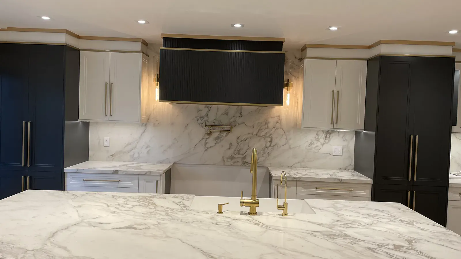 Kitchen with island, under-cabinet lighting and fixtures wired by Padi Electric